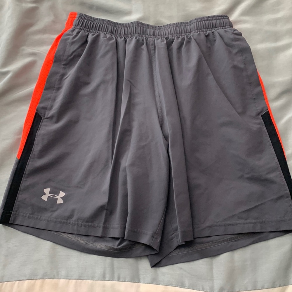 Under Armour m heat gear shorts. Gray w/orange & gray stripes w/ pockets. Size m